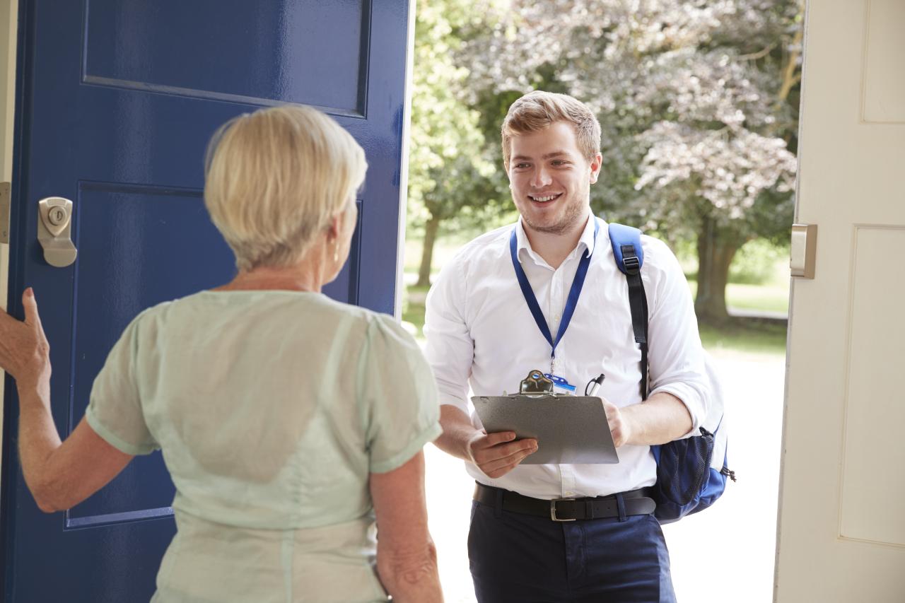 a woman opening the door to a man