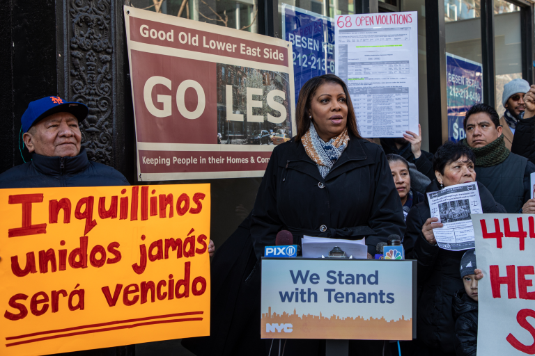 Attorney General James at a podium with other people